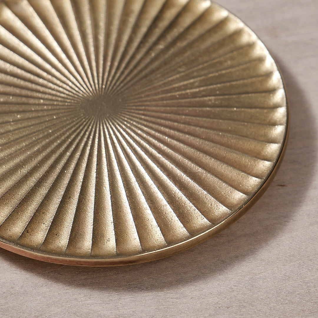 A Kobo Coaster – Solid Brass with a sunburst design on it by Futagami.