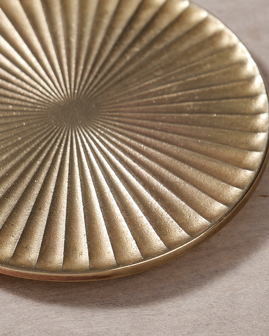 A Futagami Kobo Coaster - Solid Brass plate on a wooden surface.