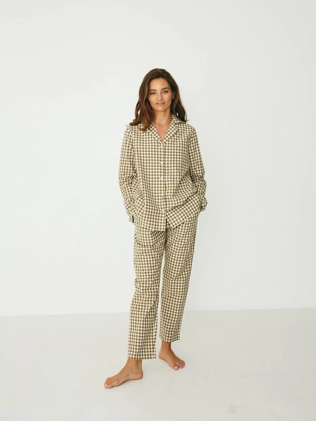 The model is wearing a Classic Set – Olive Gingham pajama set from general sleep.