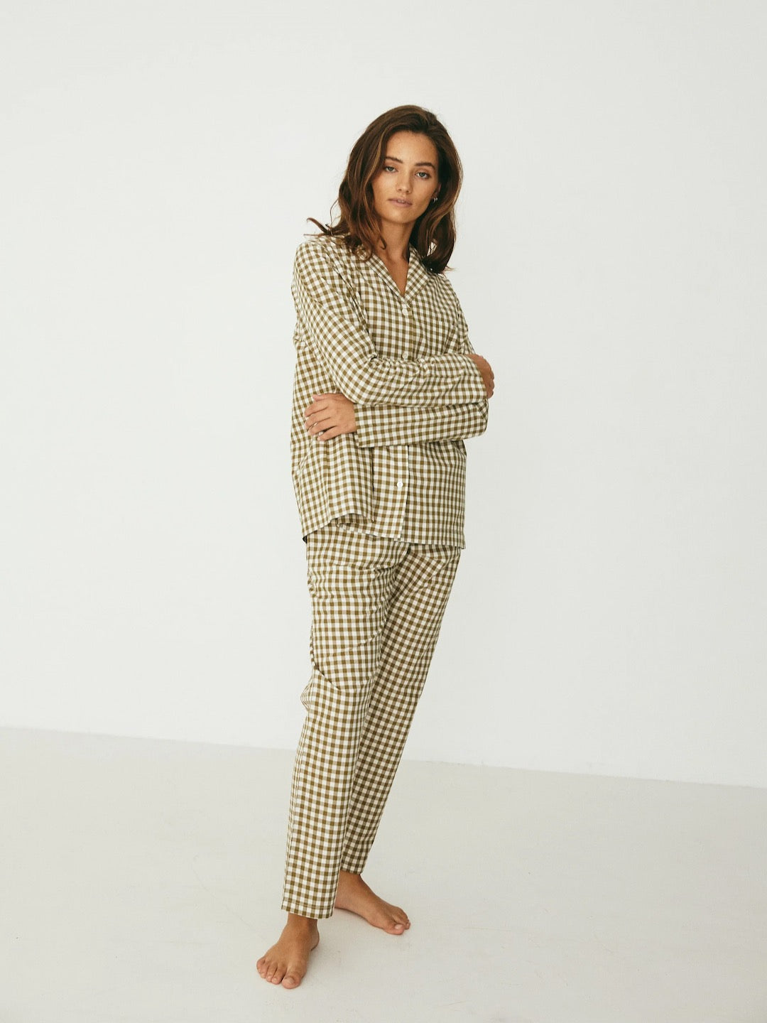 The model is wearing a Classic Set – Olive Gingham pajama set by general sleep.