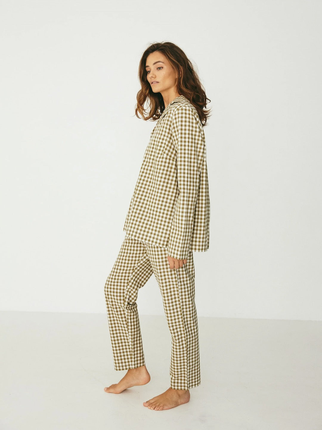 The model is wearing a Classic Set – Olive Gingham pajama set by general sleep.
