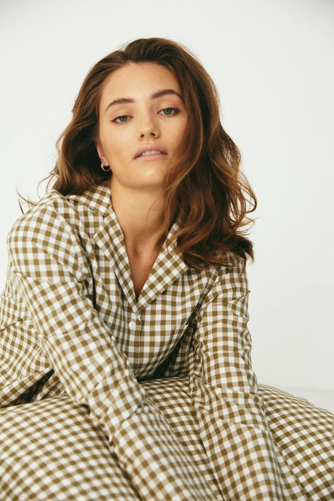 A woman in a Classic Set – Olive Gingham pajama top by general sleep.