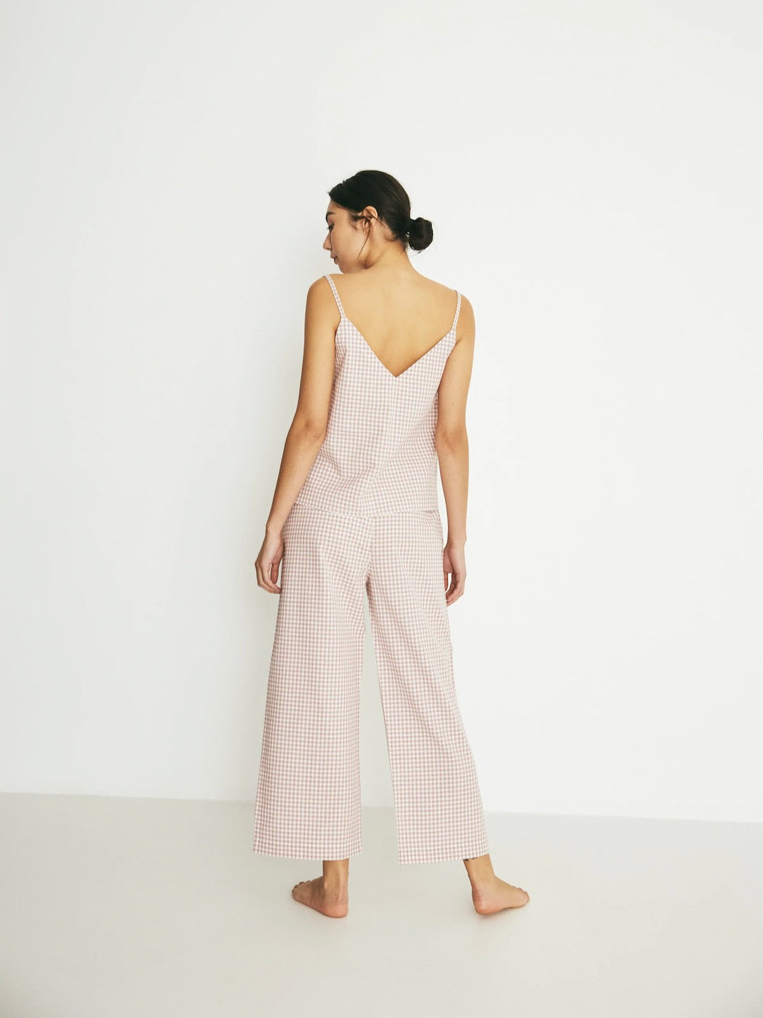 The back view of a woman in a Paloma Set - Rose Gingham jumpsuit by general sleep.