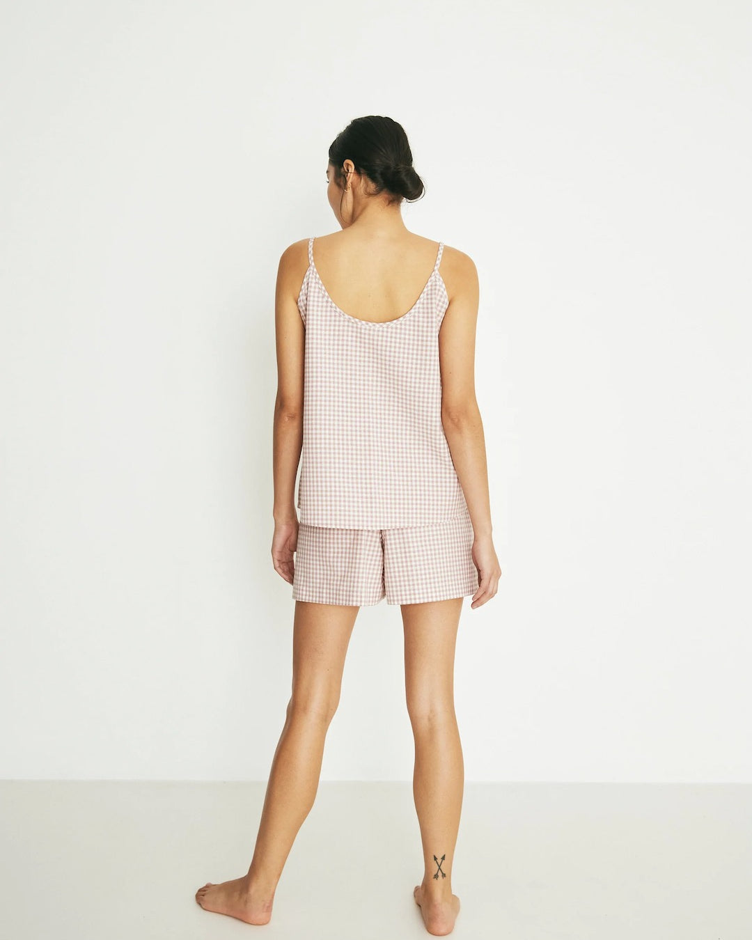 The back view of a woman in a Summer Set - Rose Gingham pajama set by general sleep.