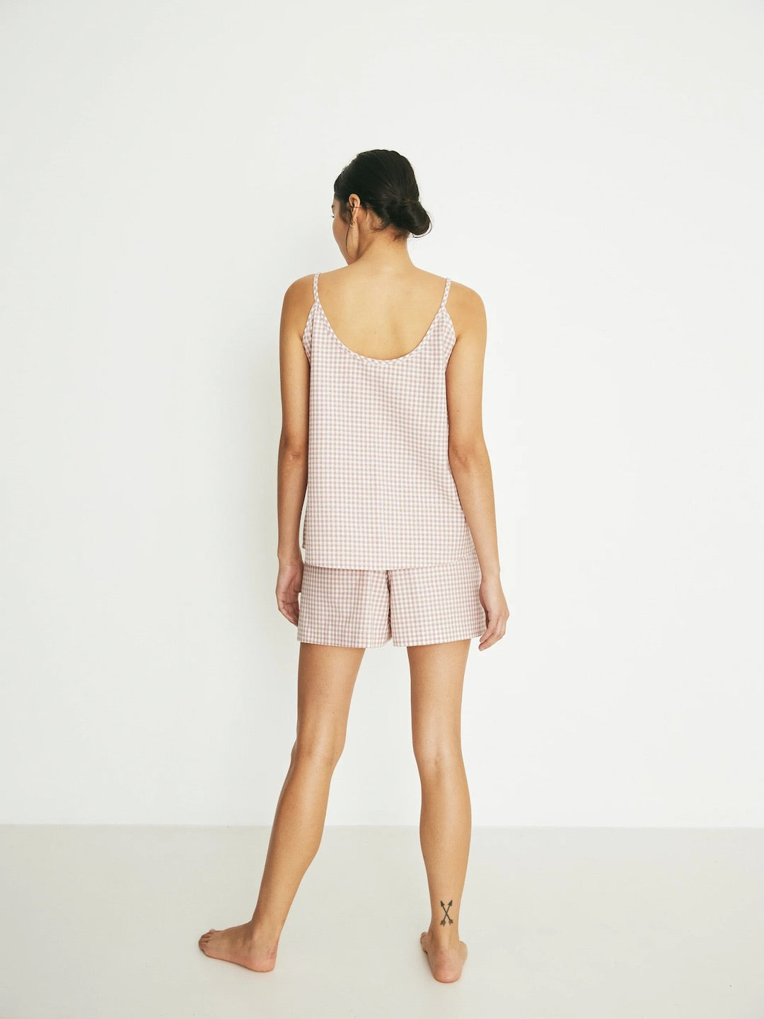 The back view of a woman in a Summer Set - Rose Gingham pajama set by general sleep.