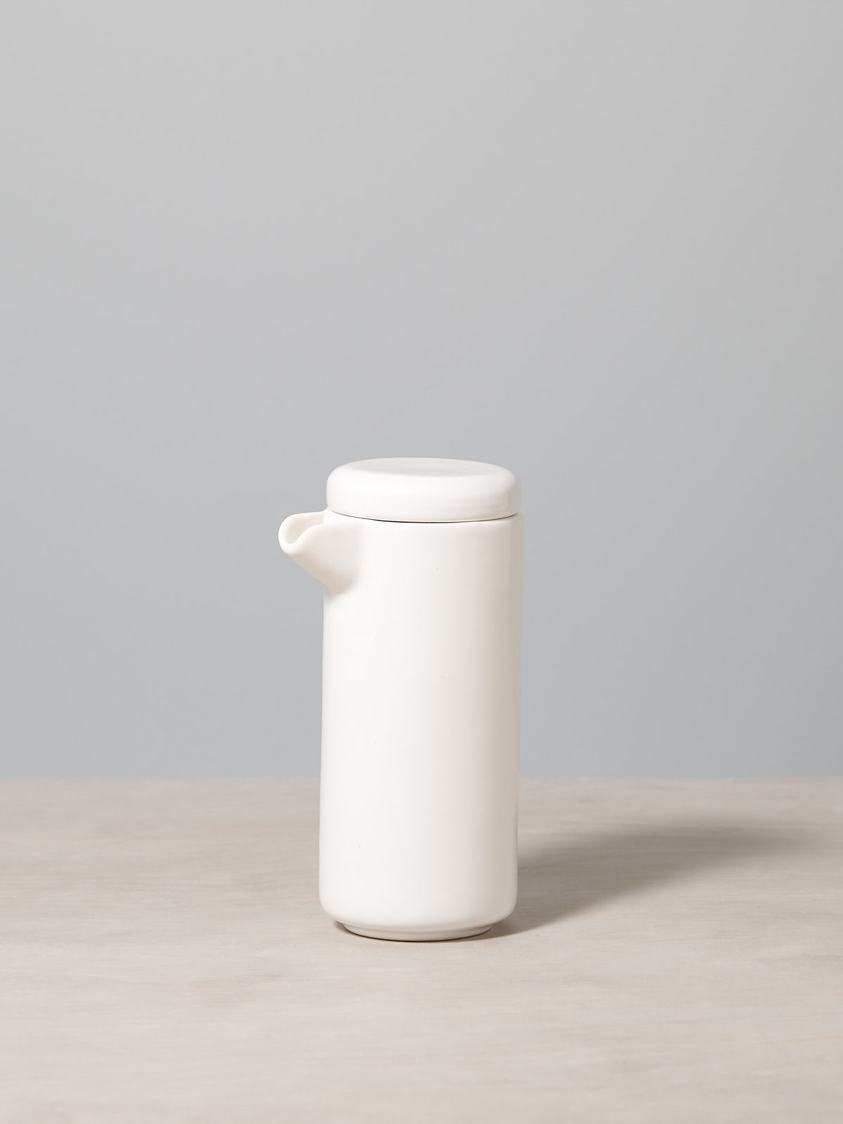 A Small Twin Wall Coffee/Tea Pot – Satin White by Gidon Bing sitting on a table.