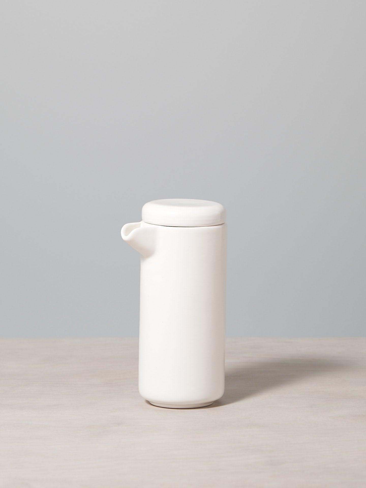 A Small Twin Wall Coffee/Tea Pot – Satin White by Gidon Bing sitting on a table.