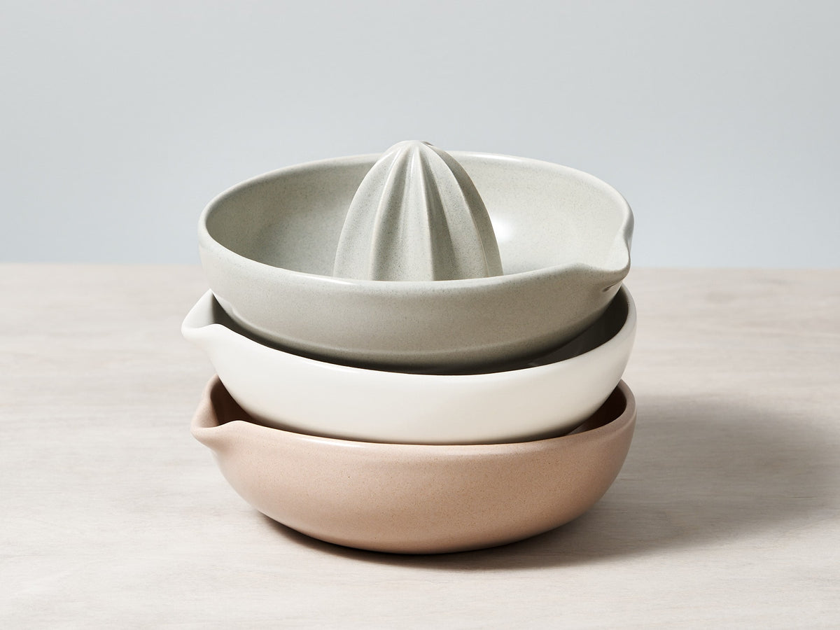 Three Citrus Juicers - Satin White by Gidon Bing stacked on top of each other.