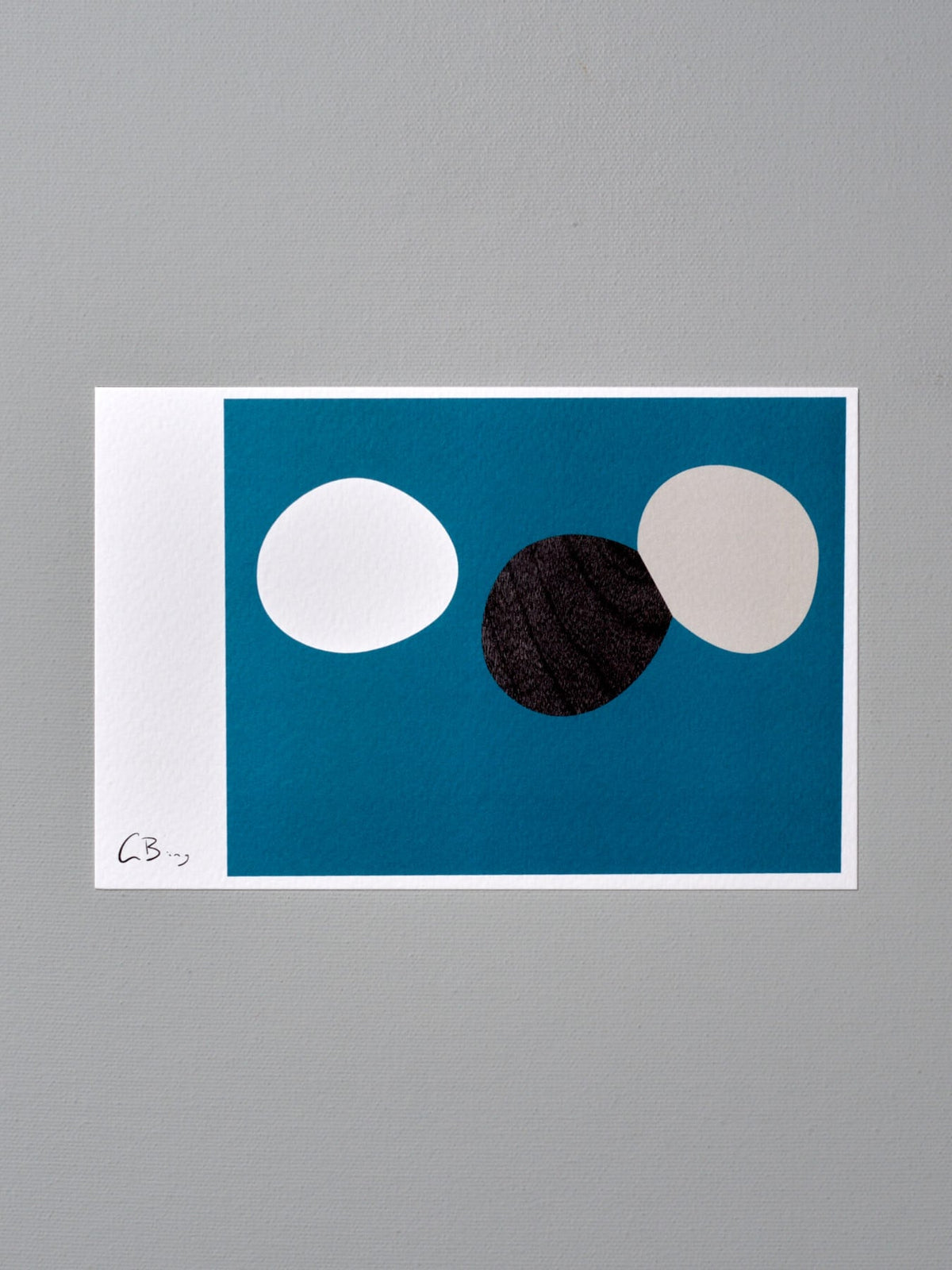 A Postcard Print - Anophase with black and white circles on a blue background by Gidon Bing.