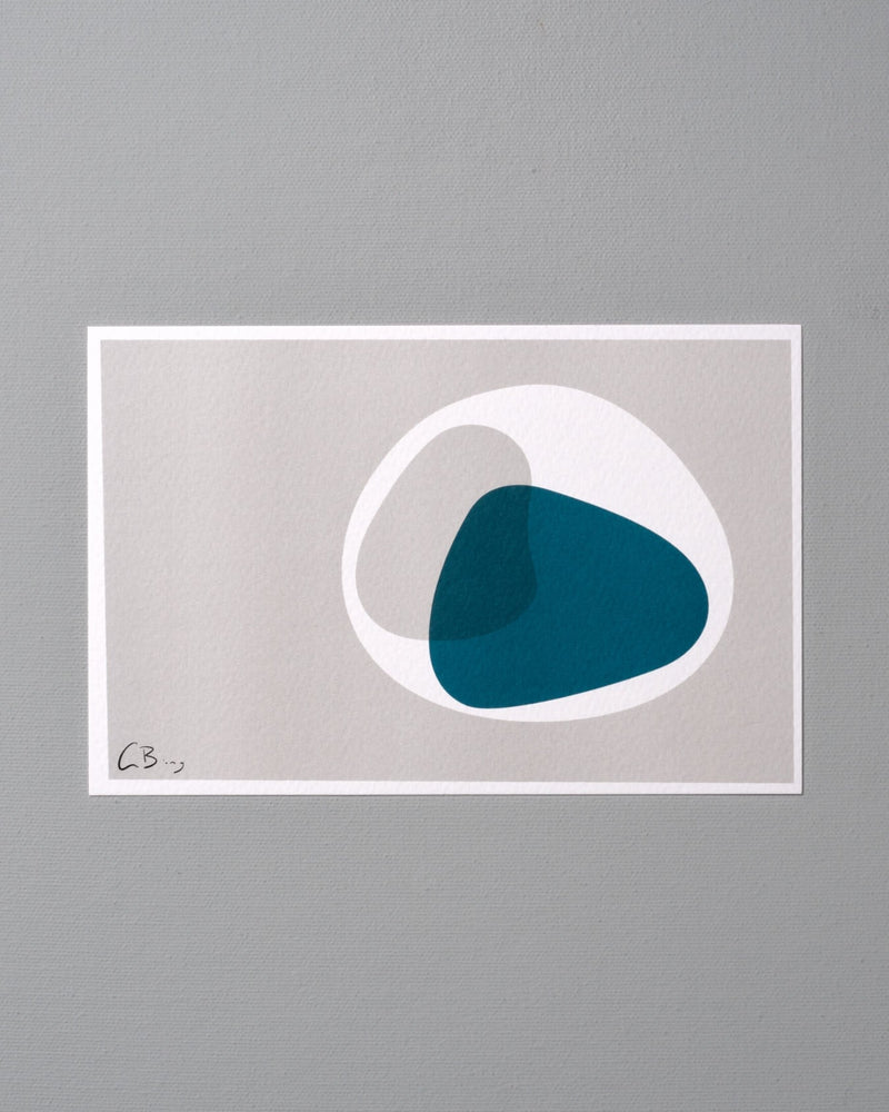 A blue and white Postcard Print - Metaphase by Gidon Bing on a gray wall.