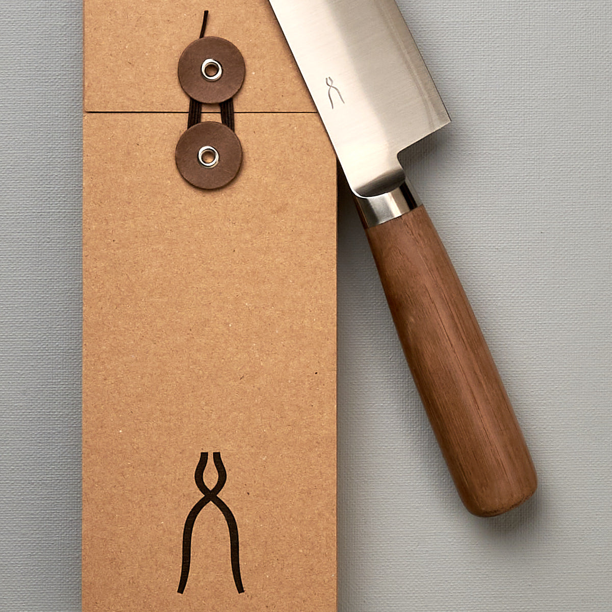 A brown box with a Tadafusa Hocho Santoku Knife on it.