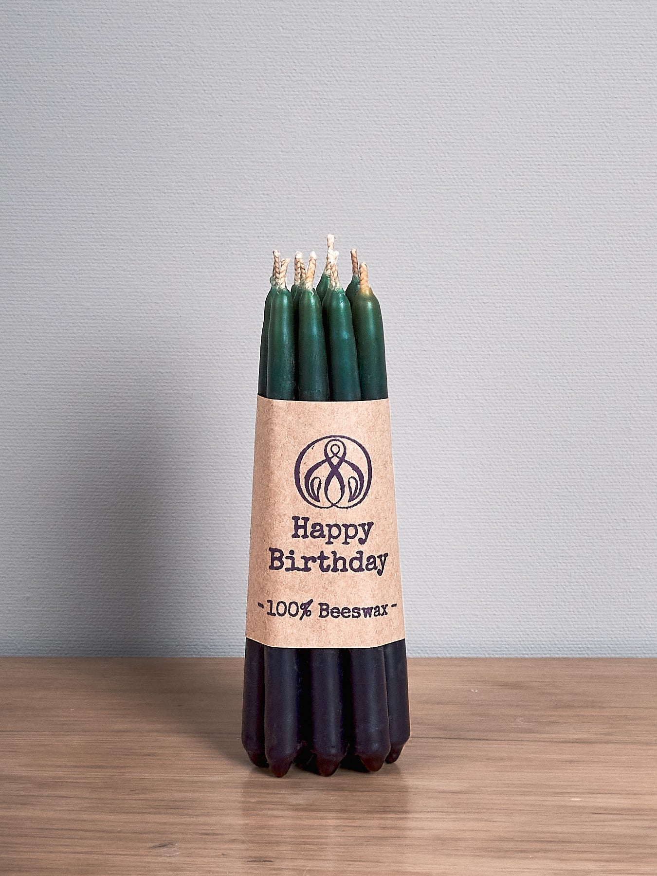 Hohepa Candles Happy Birthday Candles Set – Green, Blue & Purple on a wooden table.