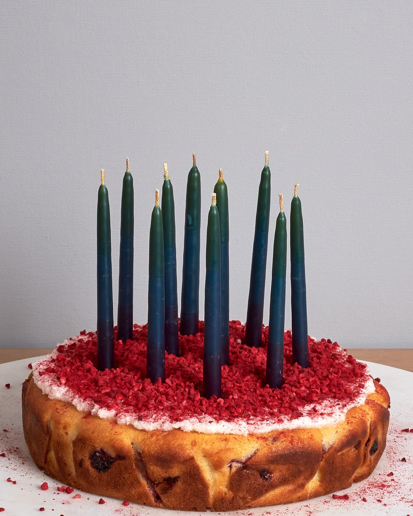 Hohepa Candles Happy Birthday Candles Set – Green, Blue & Purple on a wooden table.