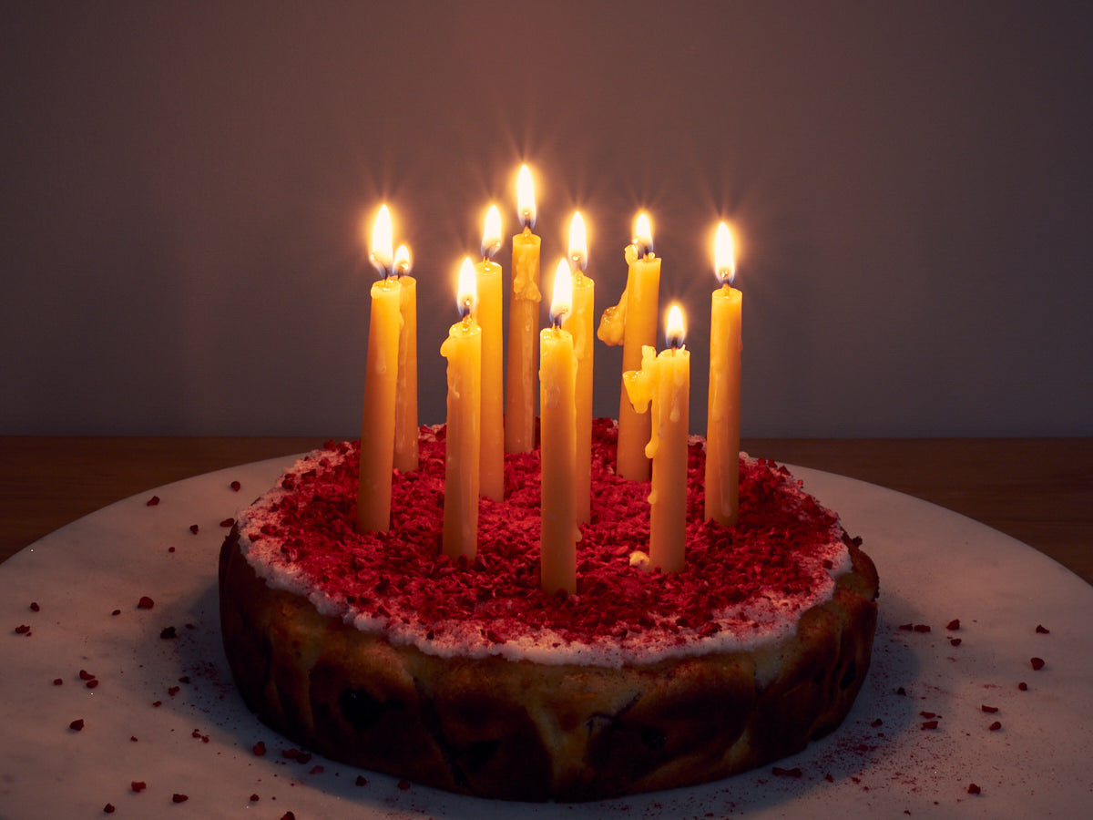 A Birthday Candles Set - Natural by Hohepa Candles on a cake.
