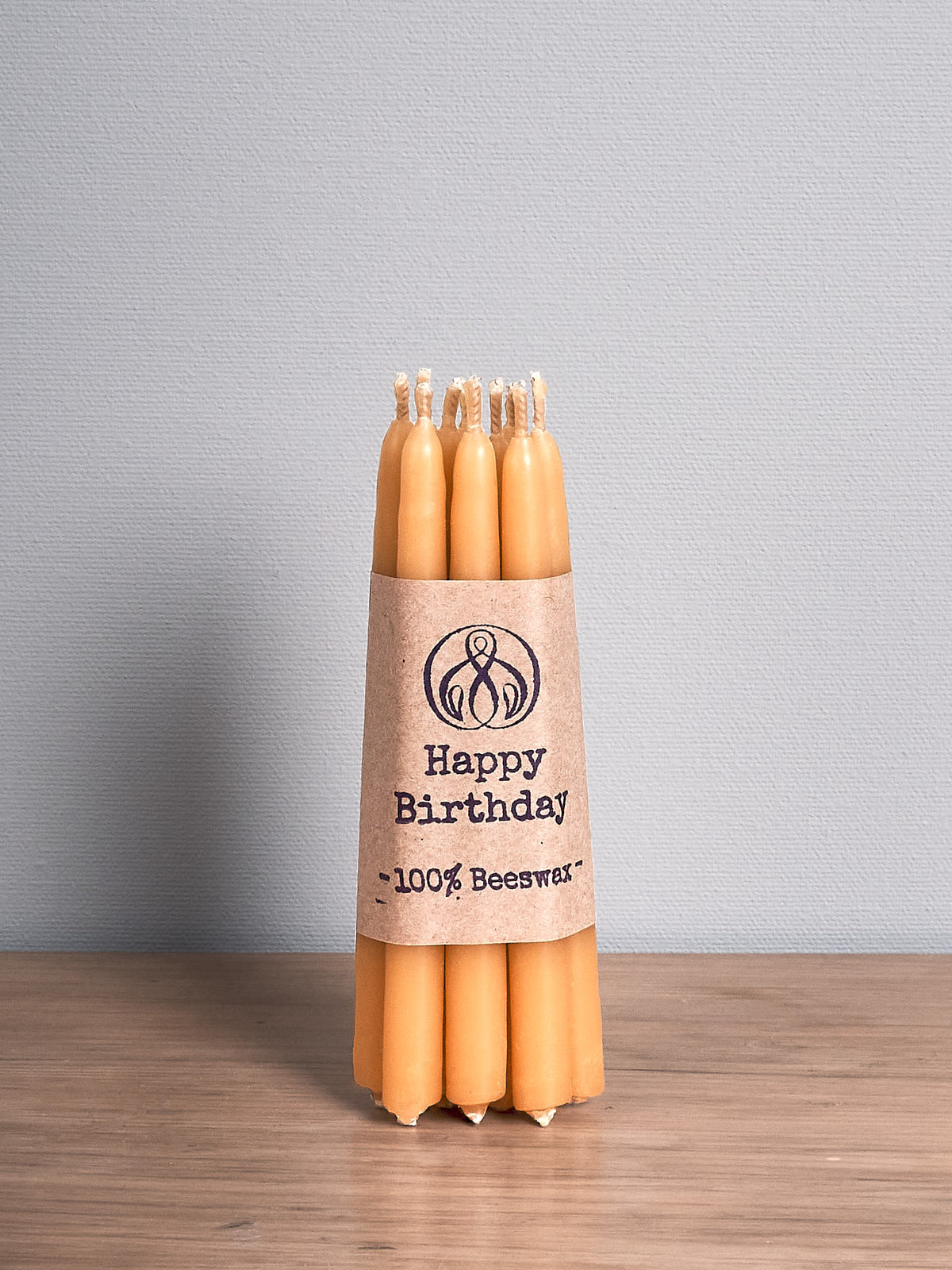 A Hohepa Candles Birthday Candles Set – Natural on a wooden table.
