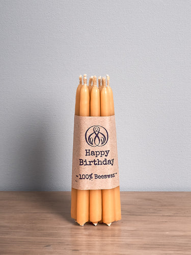 A Hohepa Candles Birthday Candles Set – Natural on a wooden table.