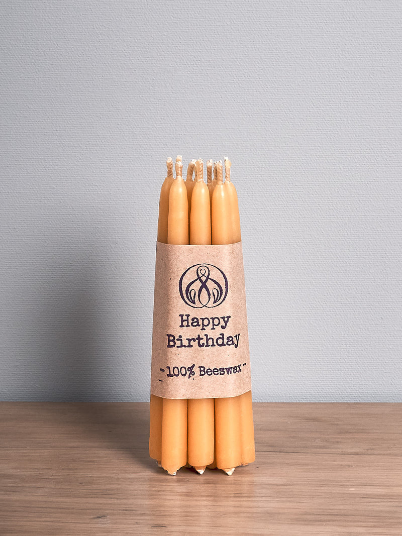 A Hohepa Candles Birthday Candles Set – Natural on a wooden table.