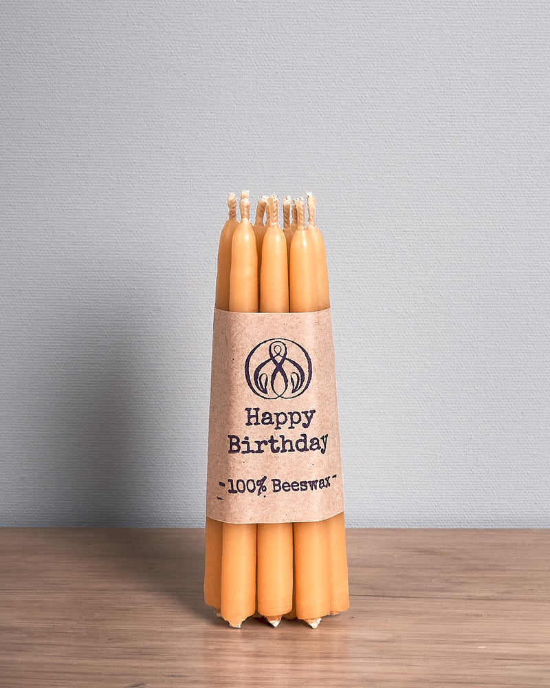 A Hohepa Candles Birthday Candles Set – Natural on a wooden table.