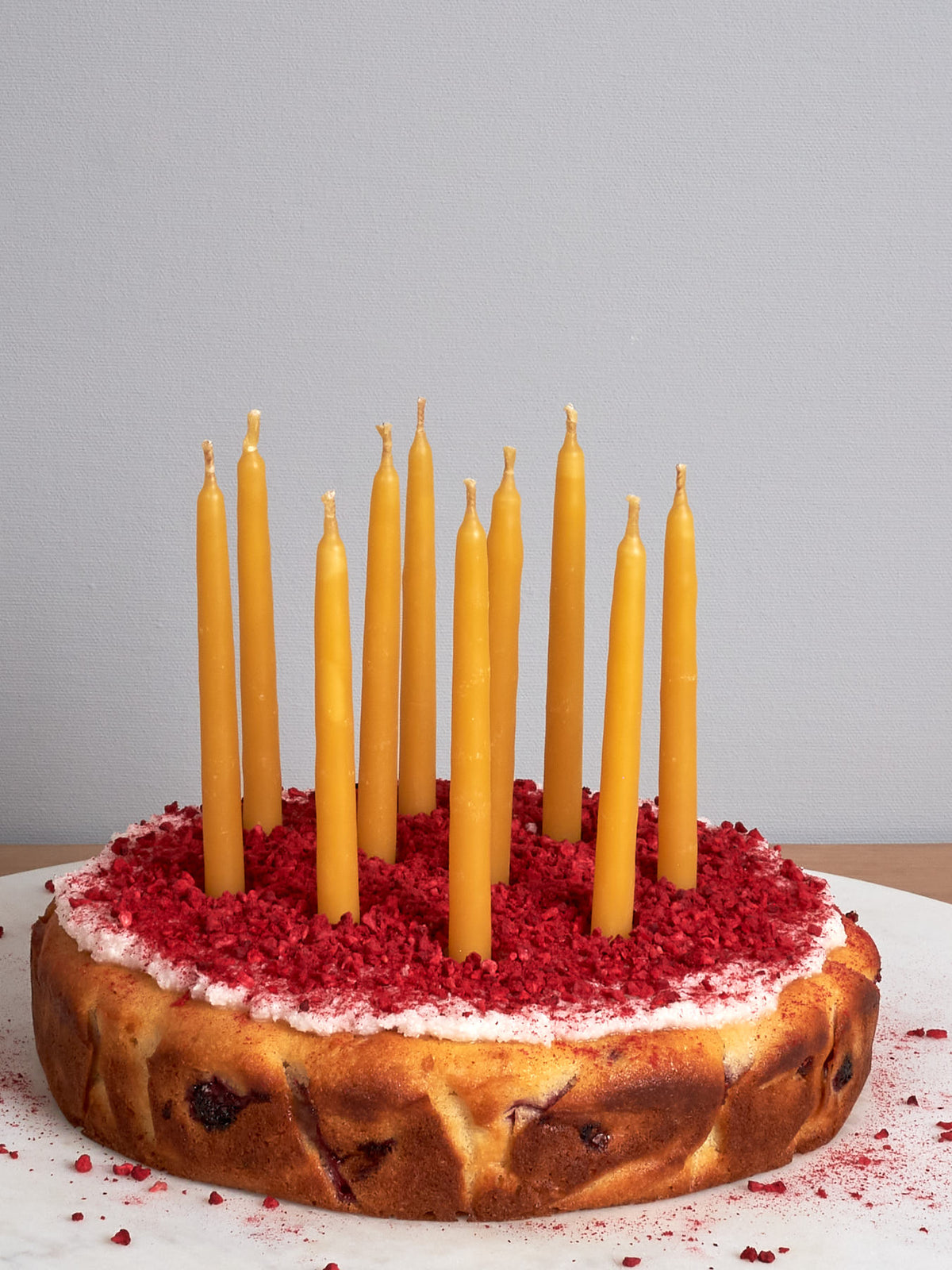 A cake with Hohepa Candles&#39; Birthday Candles Set – Natural on top of it.