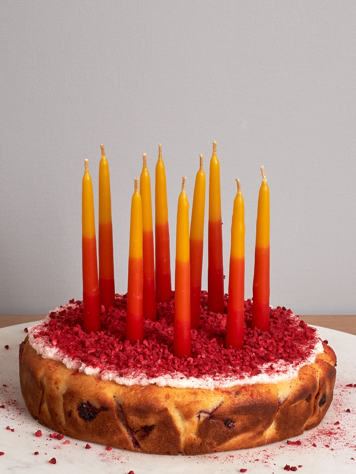 A cake with Hohepa Candles&#39; Birthday Candles Set - Red, Orange &amp; Yellow on top.