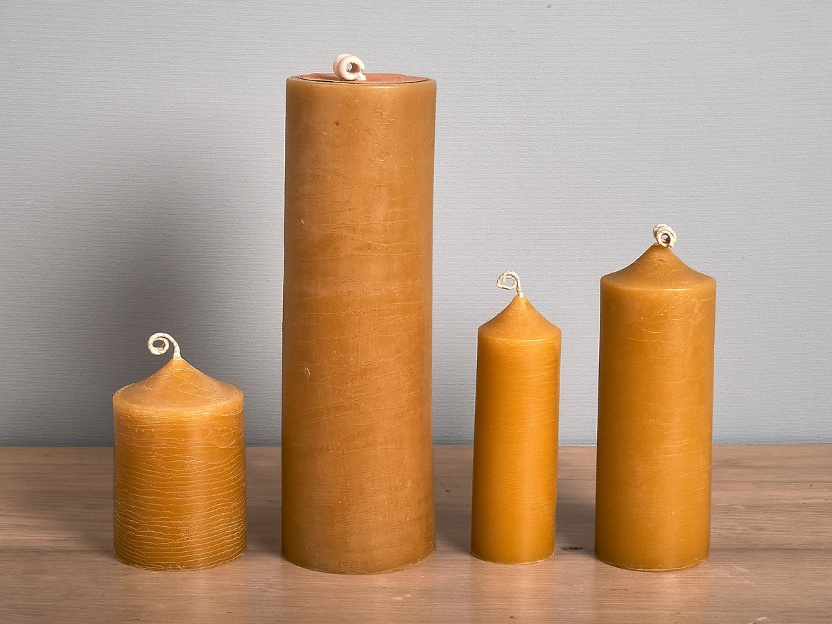 Four Cafe Candles - Tall by Hohepa Candles on a wooden table.