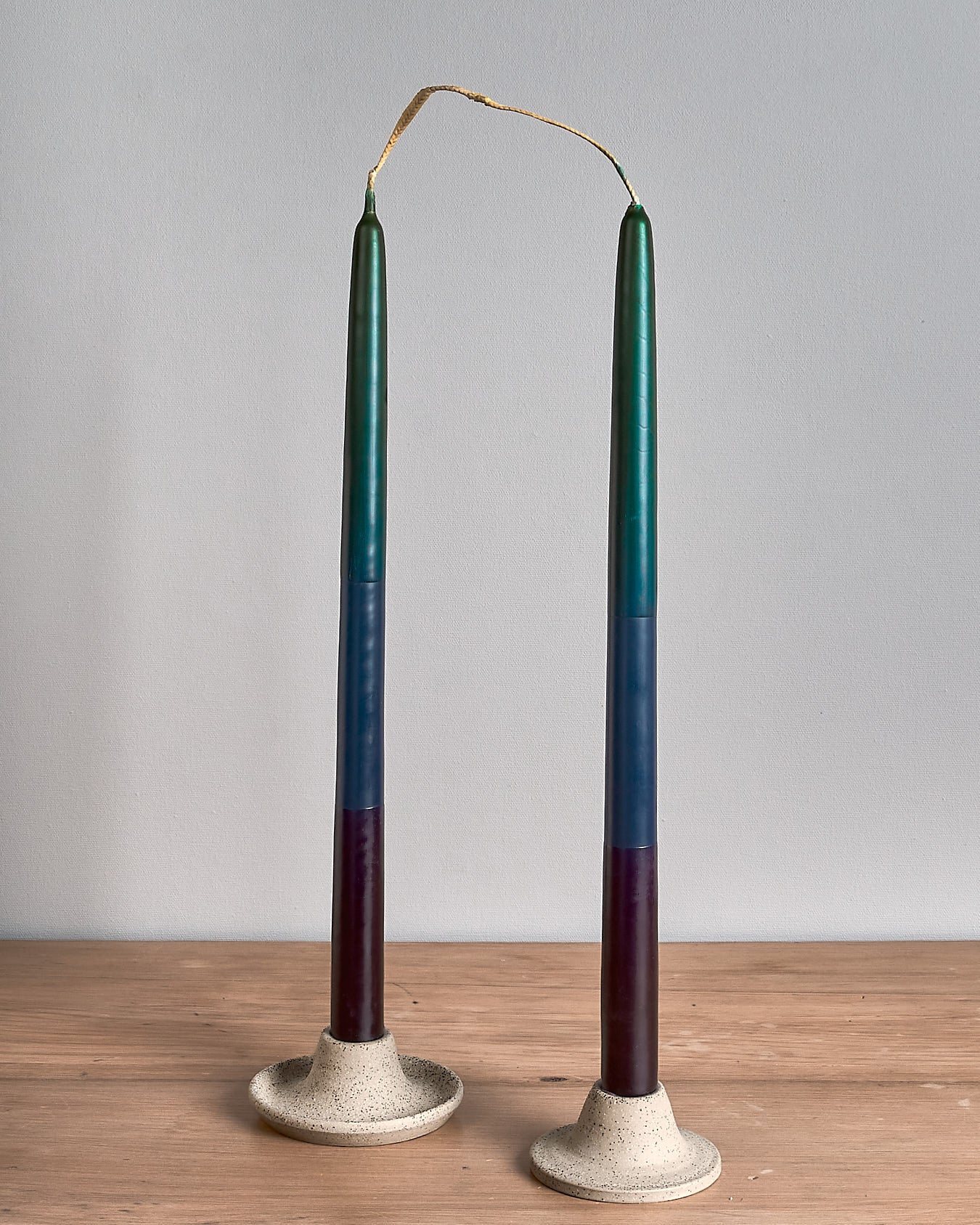 Two Hohepa Candles Dinner Candle Sets – Green, Blue & Purple on a wooden table.
