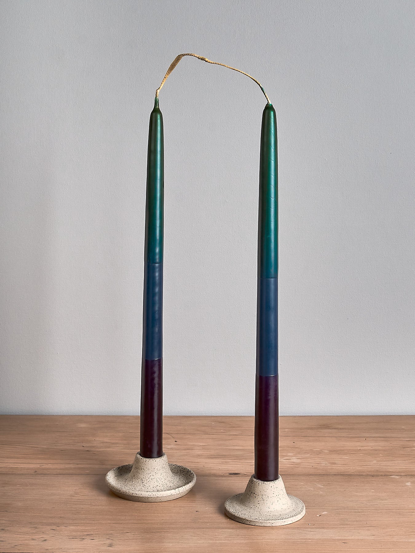 Two Hohepa Candles Dinner Candle Sets – Green, Blue & Purple on a wooden table.