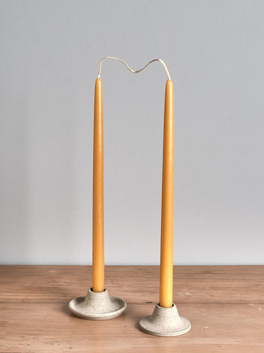 Two Hohepa Candles Dinner Candle Set – Natural candle holders on a wooden table.