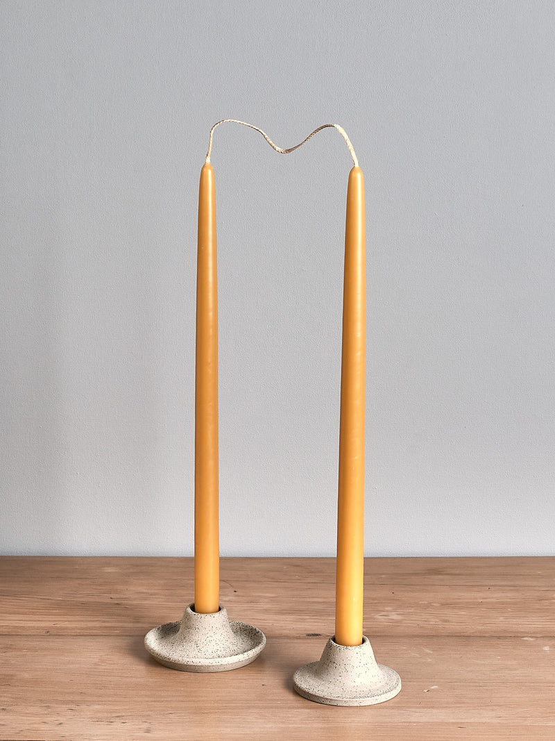 Two Hohepa Candles Dinner Candle Set – Natural candle holders on a wooden table.