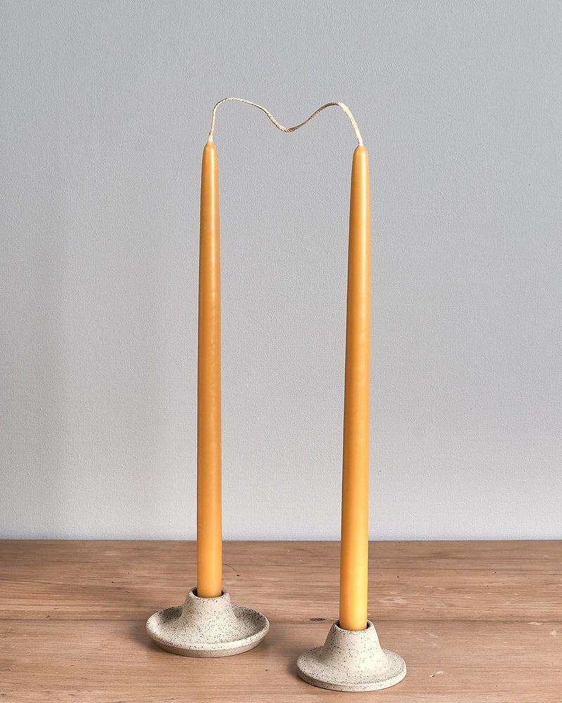 Two Hohepa Candles Dinner Candle Set – Natural candle holders on a wooden table.