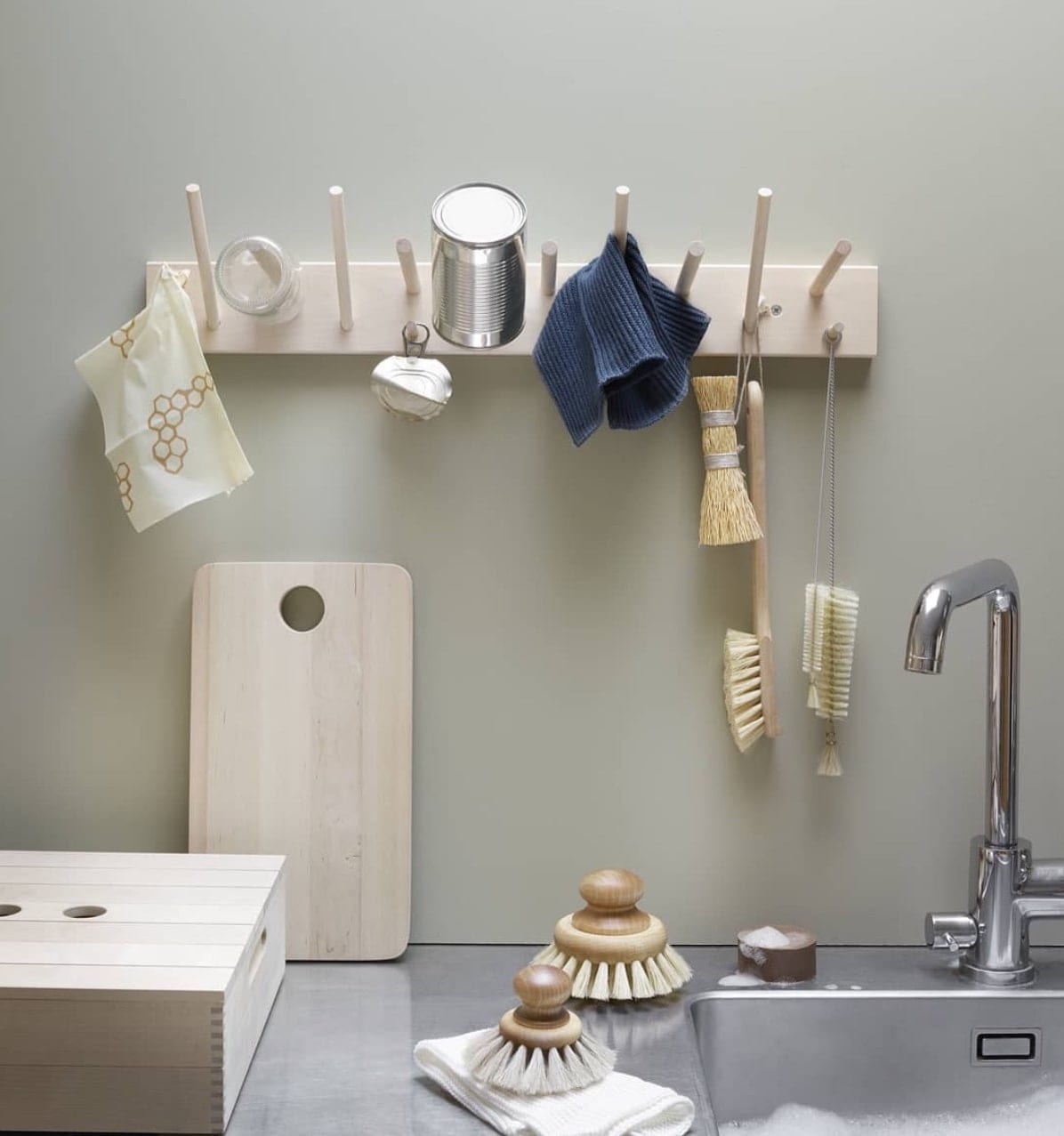 A kitchen with a sink and Iris Hantverk&#39;s Linen Household Cloth – Four Colours hanging on a rack.