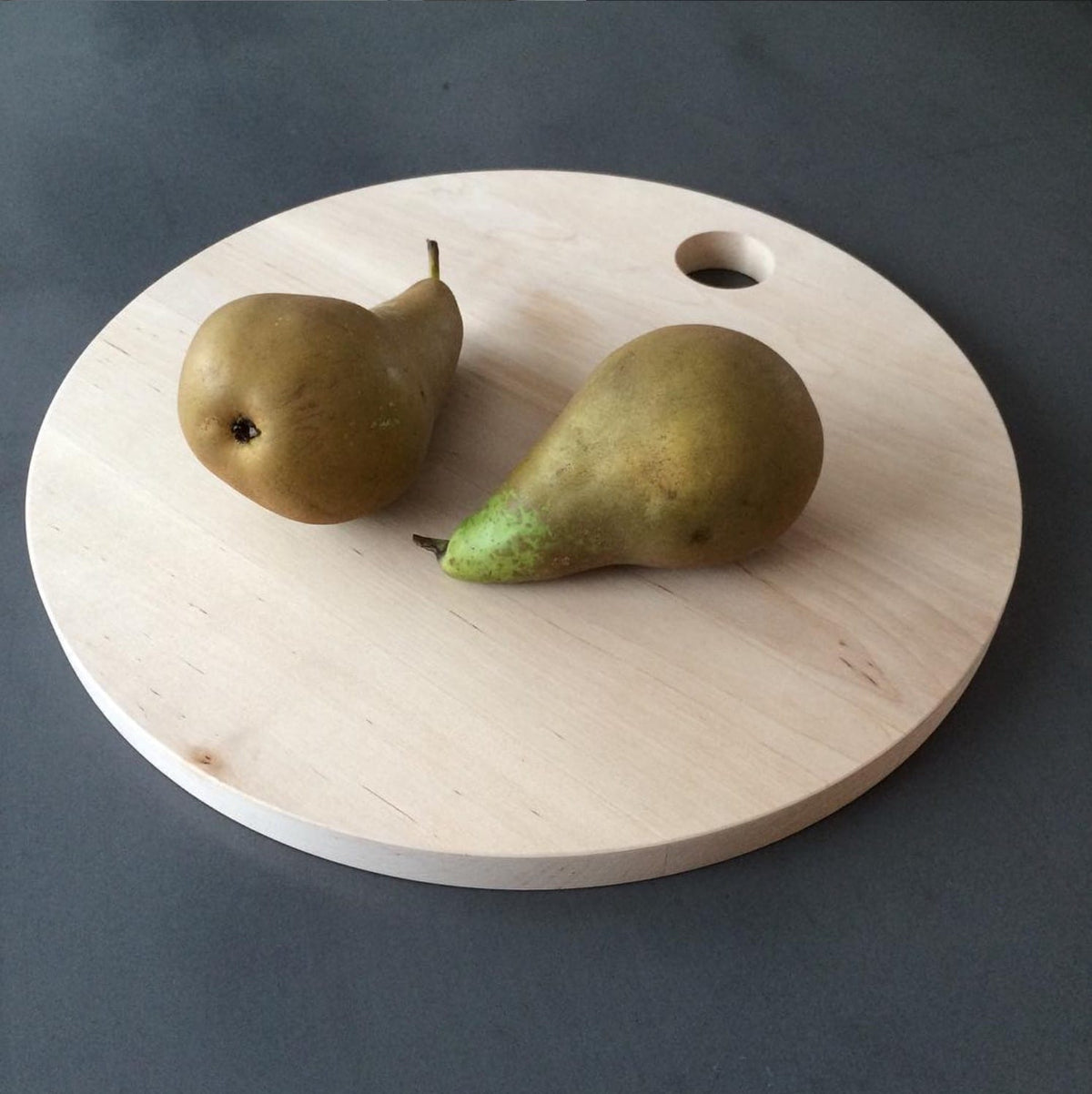 Two pears on an Iris Hantverk Birch Chopping Board – Round.