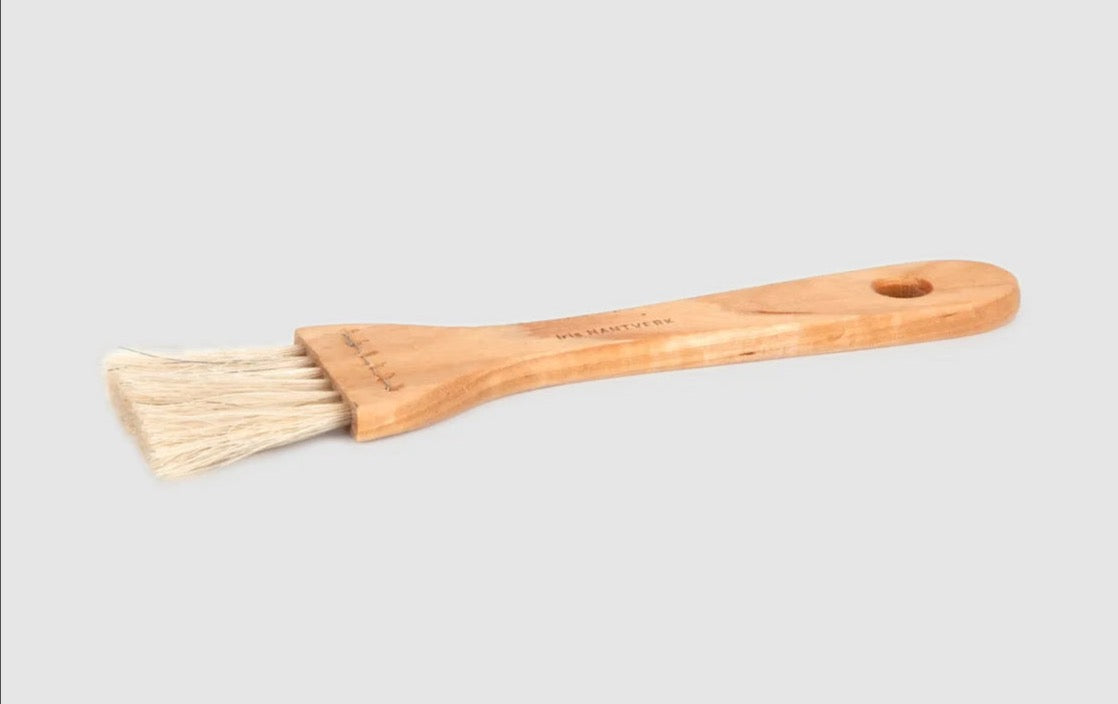 An Iris Hantverk Pastry Brush – Waxed Birch &amp; Horsehair with a handle on a white background.