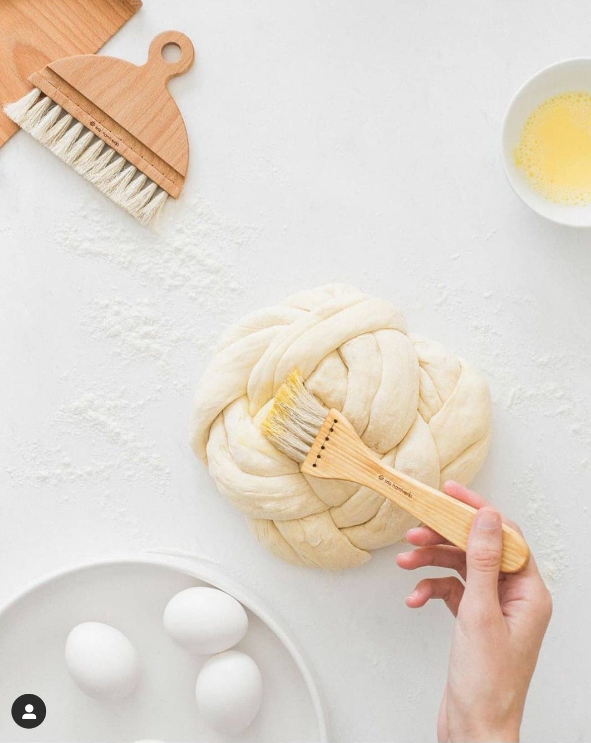 A person is using a Pastry Brush – Waxed Birch &amp; Horsehair from Iris Hantverk to knead dough.
