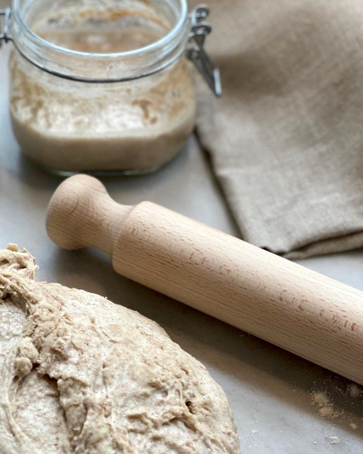 An Iris Hantverk Beechwood Rolling Pin on a grey background.