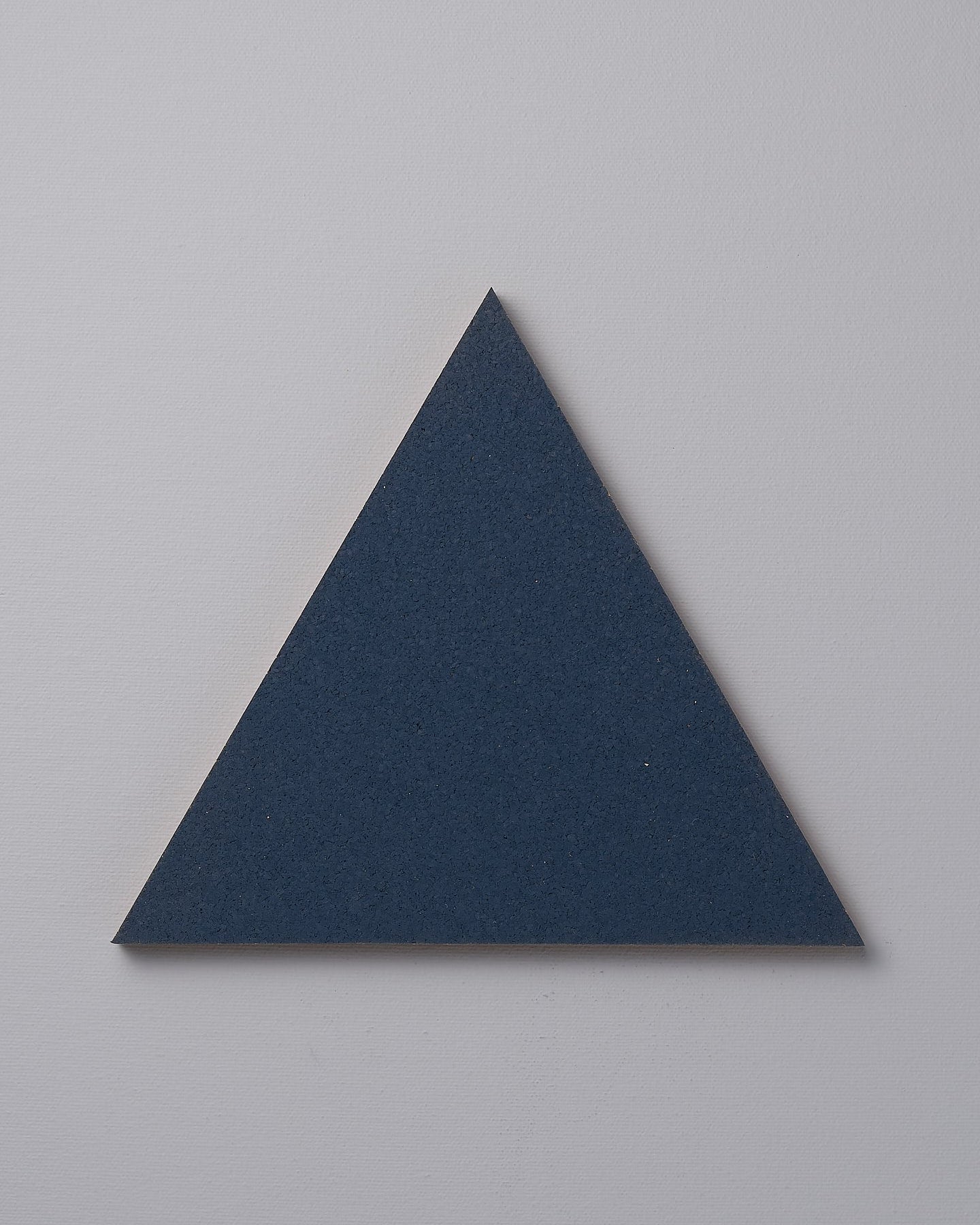 An Iris Hantverk Orion Blue trivet on a white background.