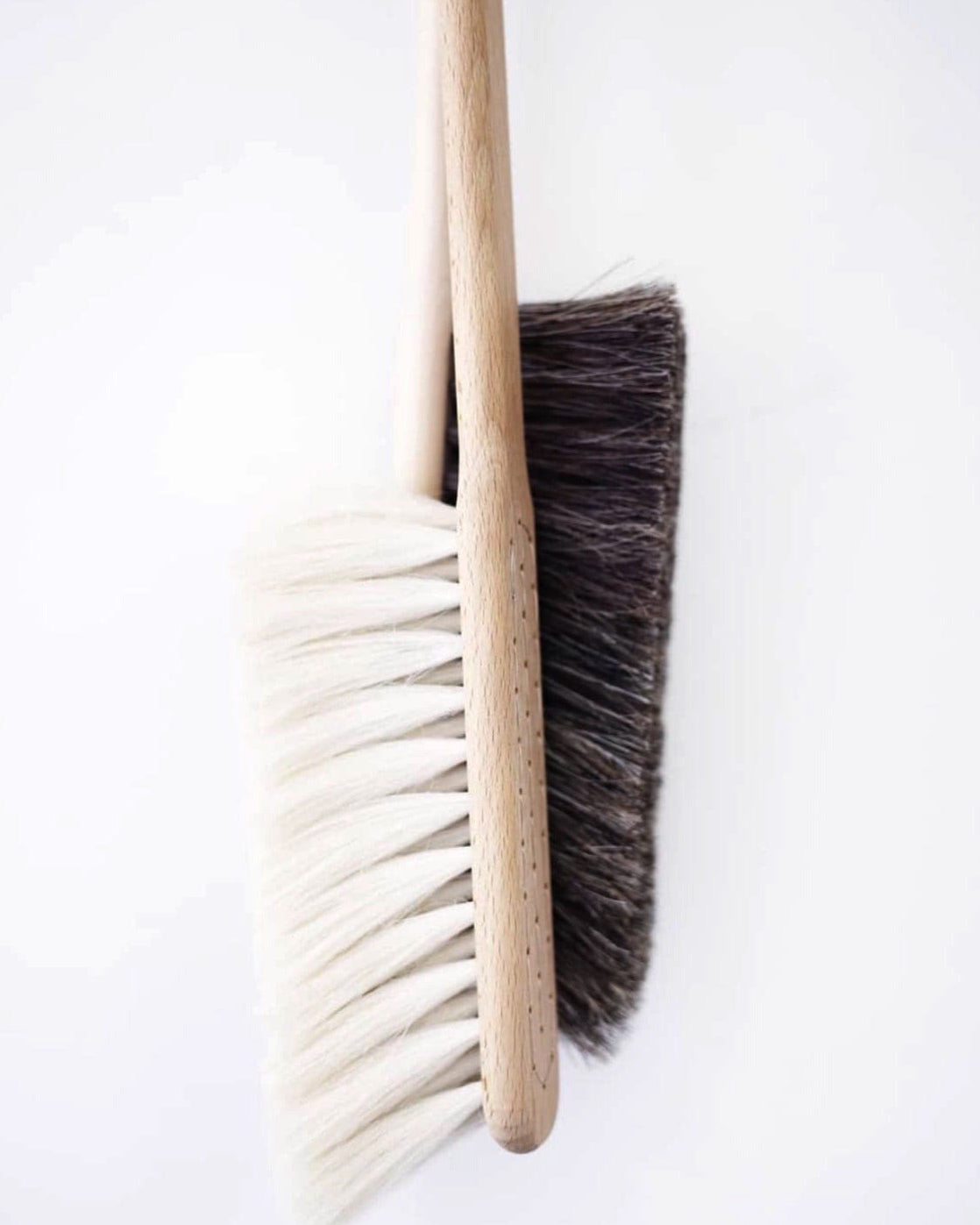 Two Iris Hantverk Dust Brushes – Beechwood & Goat Hair on a white surface.
