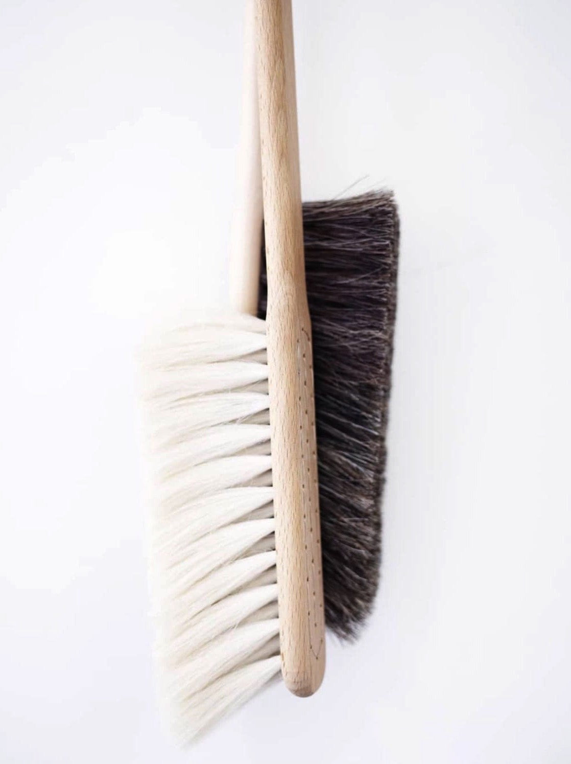 Two Iris Hantverk Dust Brushes – Beechwood &amp; Goat Hair on a white surface.