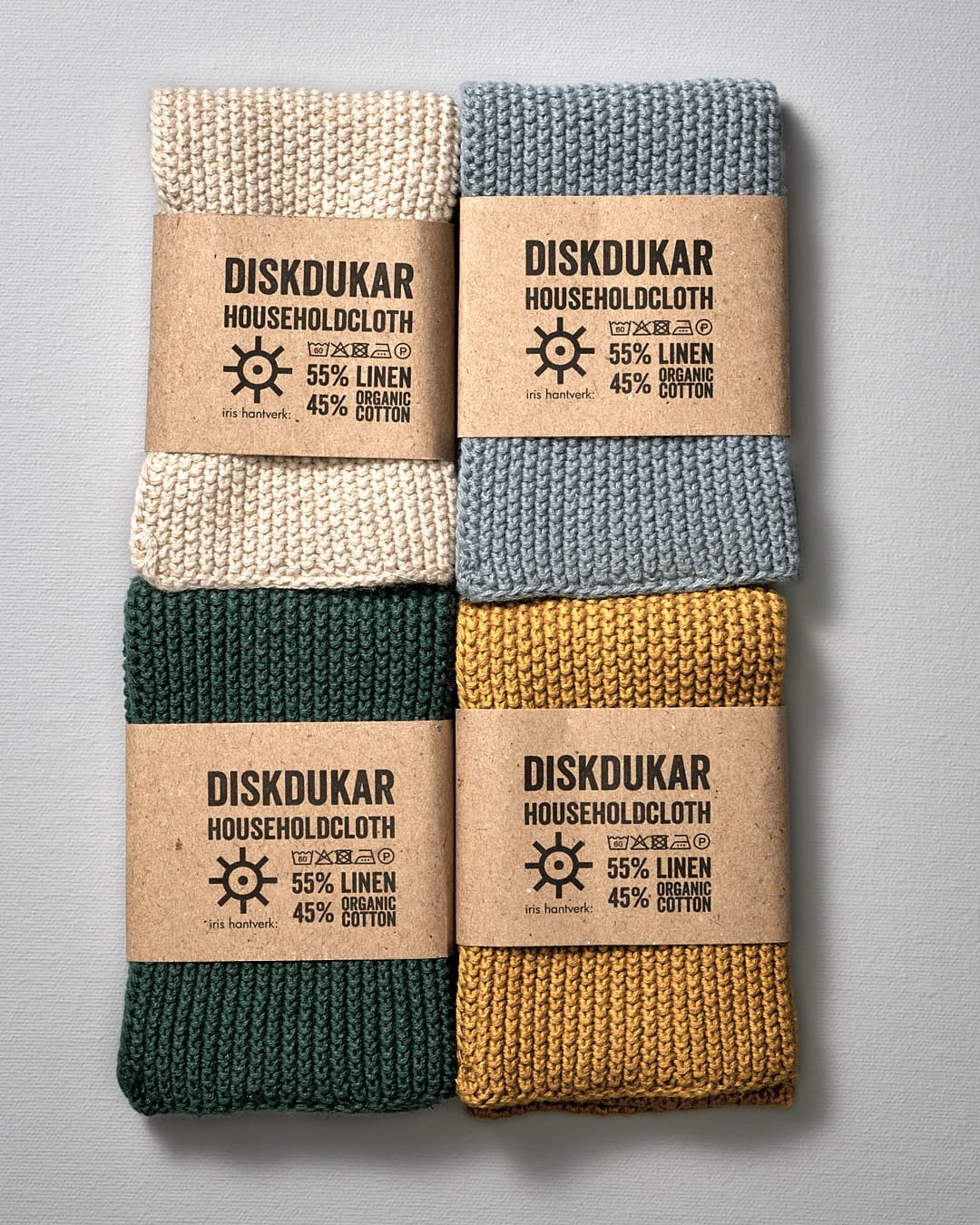 A set of four Iris Hantverk Linen Household Cloth – Four Colours with labels on them for use as household cloth.