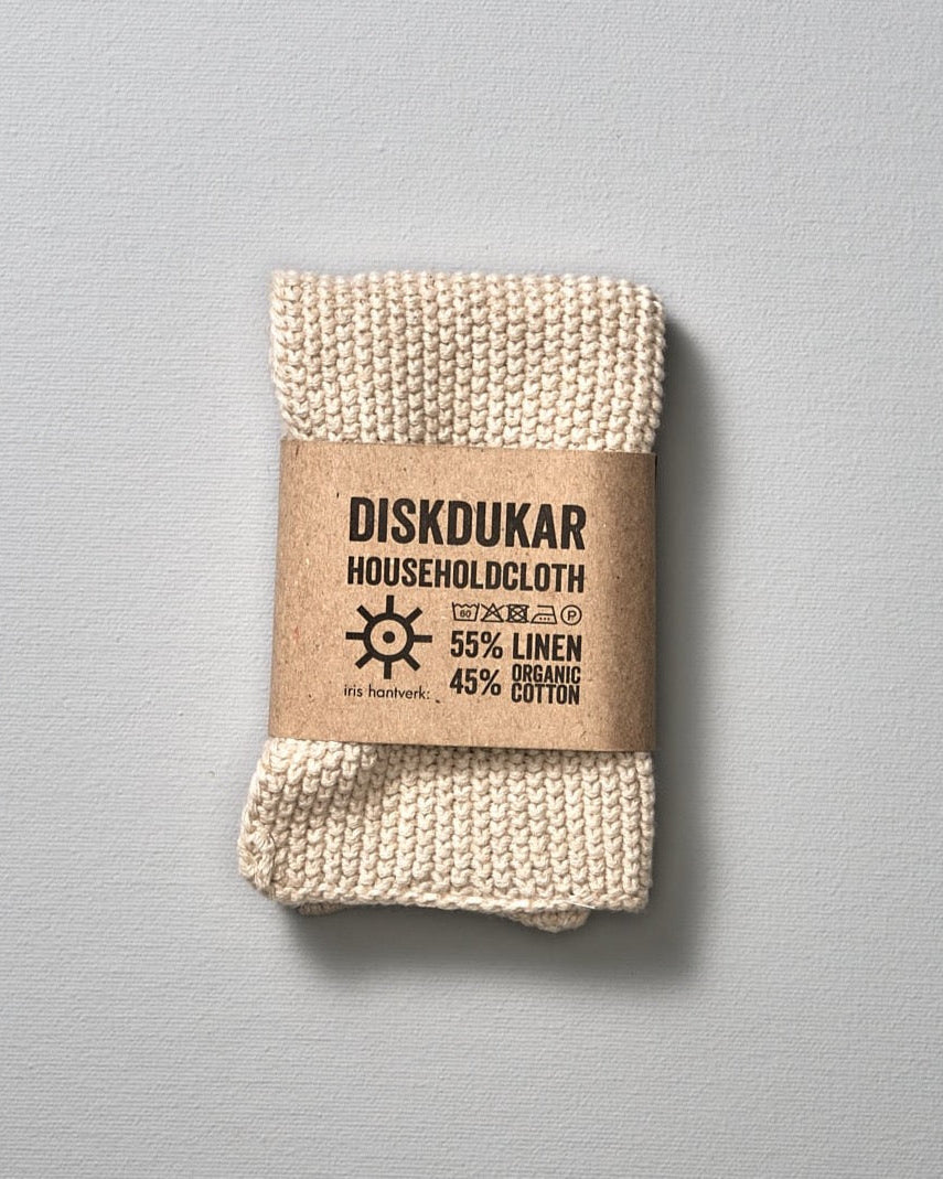 A white Linen Household Cloth – Four Colours with the word diskusar on it, crafted from a linen/cotton blend for optimal absorbency by Iris Hantverk.
