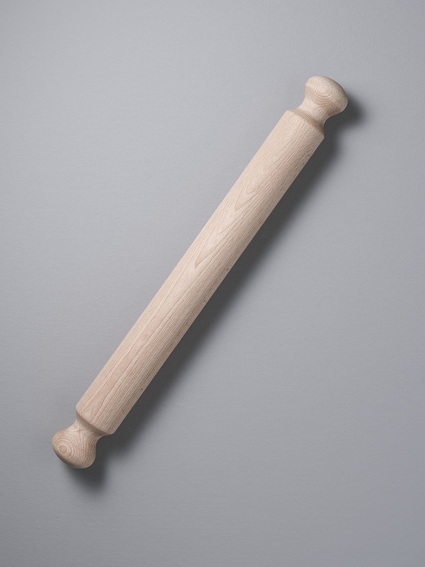 An Iris Hantverk Beechwood Rolling Pin on a grey background.