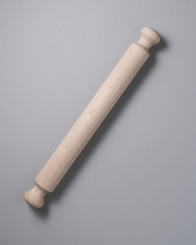 An Iris Hantverk Beechwood Rolling Pin on a grey background.