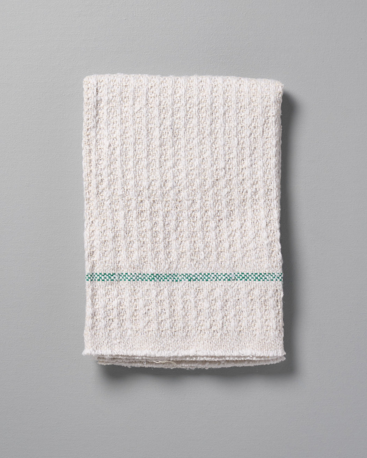 An Iris Hantverk Cleaning Cloth with a green stripe.