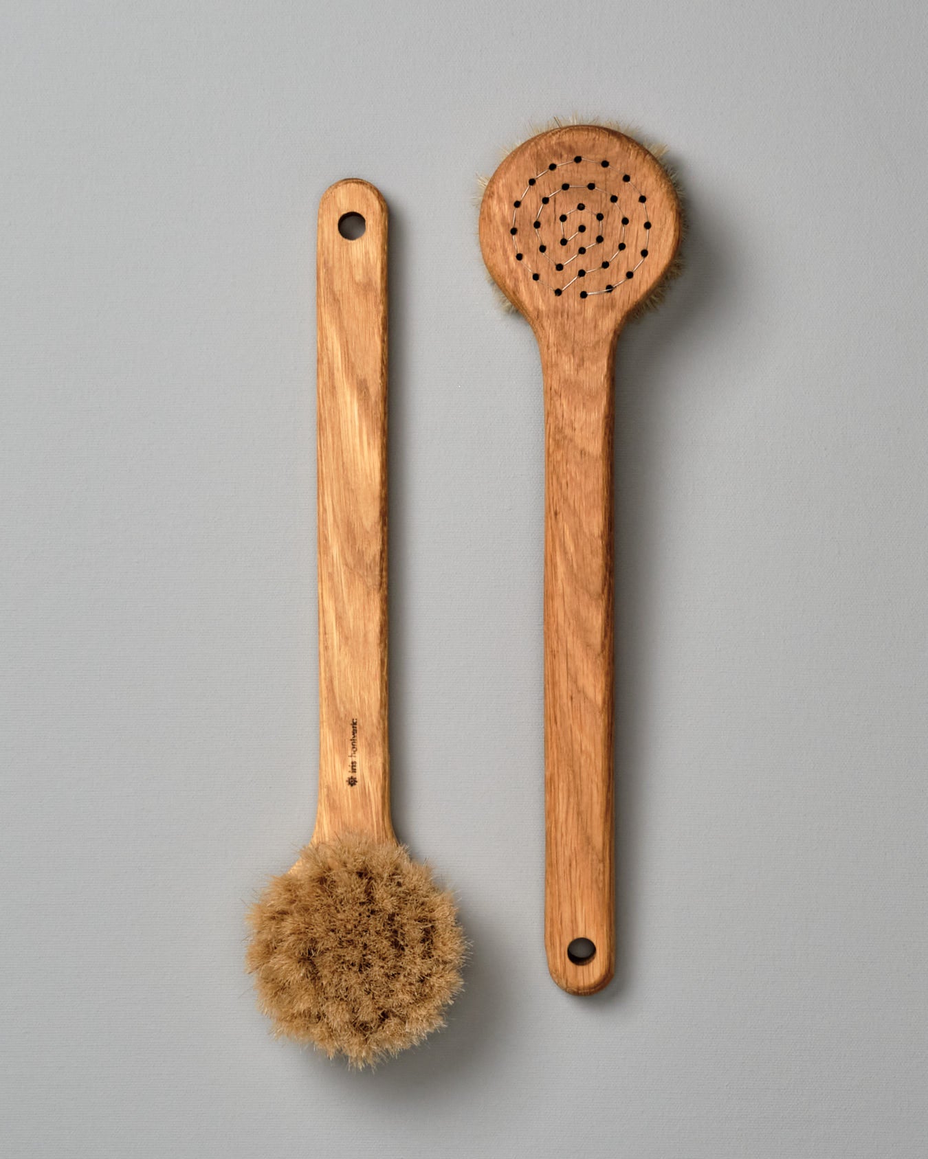 Two Iris Hantverk Body Brushes – Round Head on a grey background.