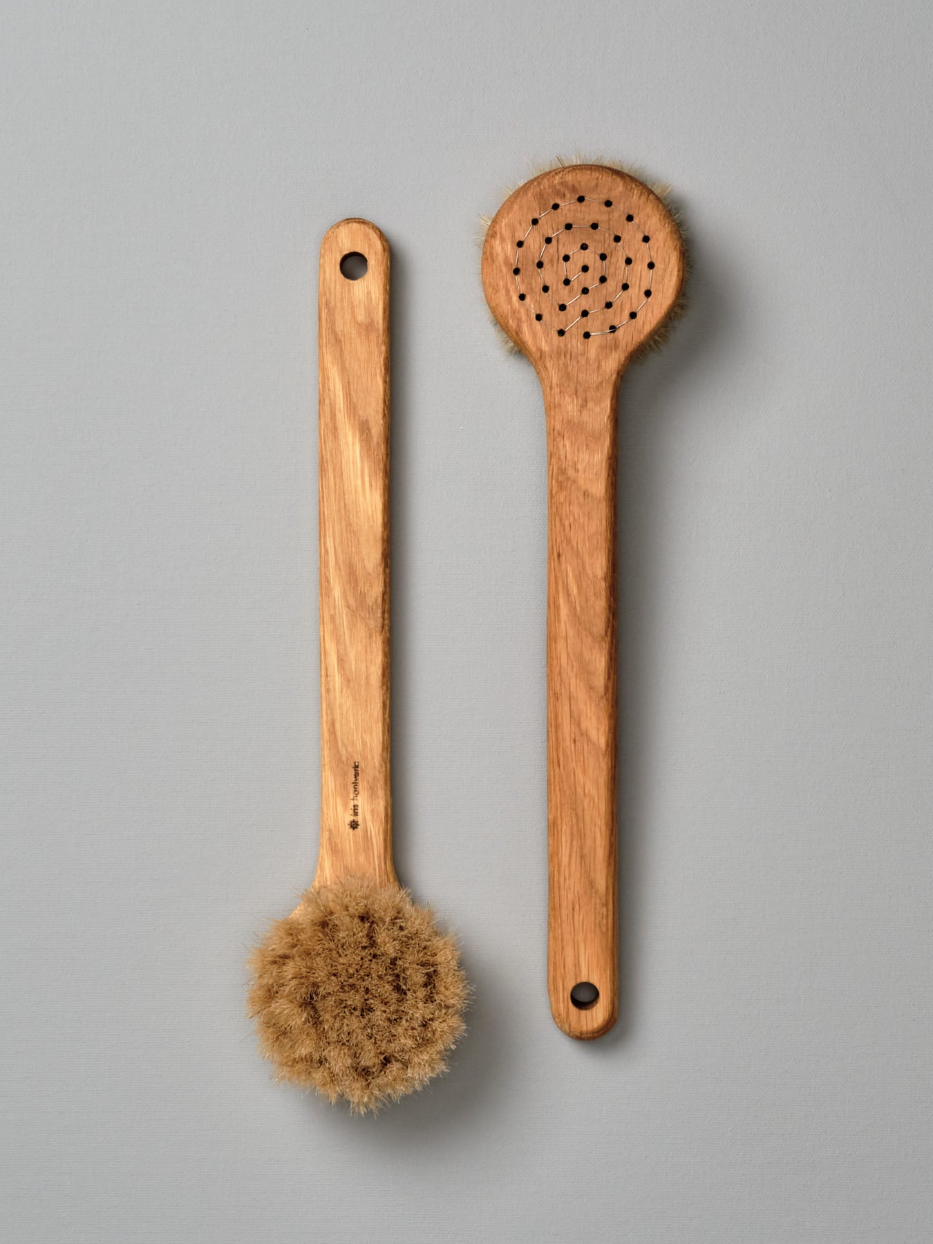 Two Iris Hantverk Body Brushes – Round Head on a grey background.