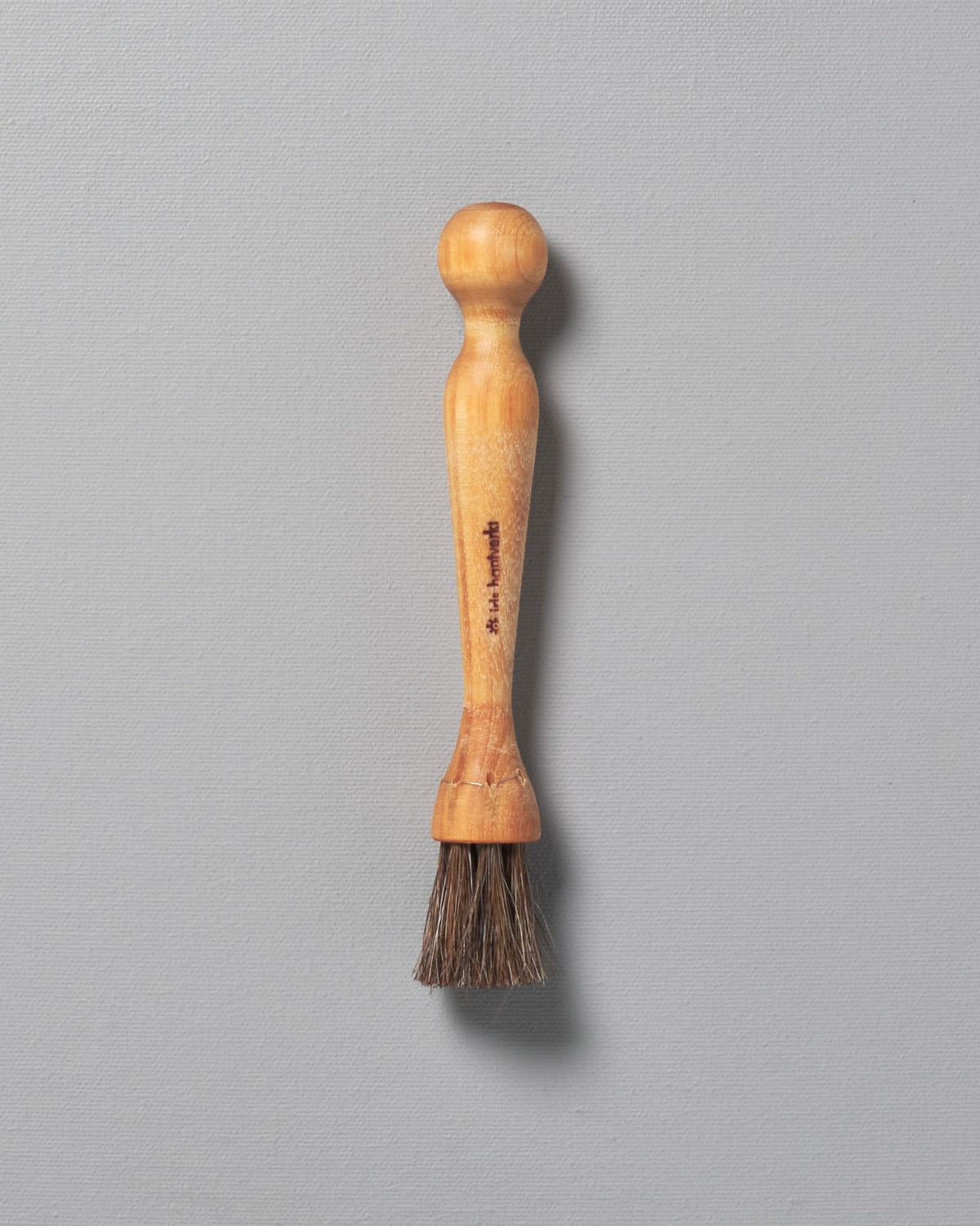 An Iris Hantverk Mushroom Brush on a grey background.