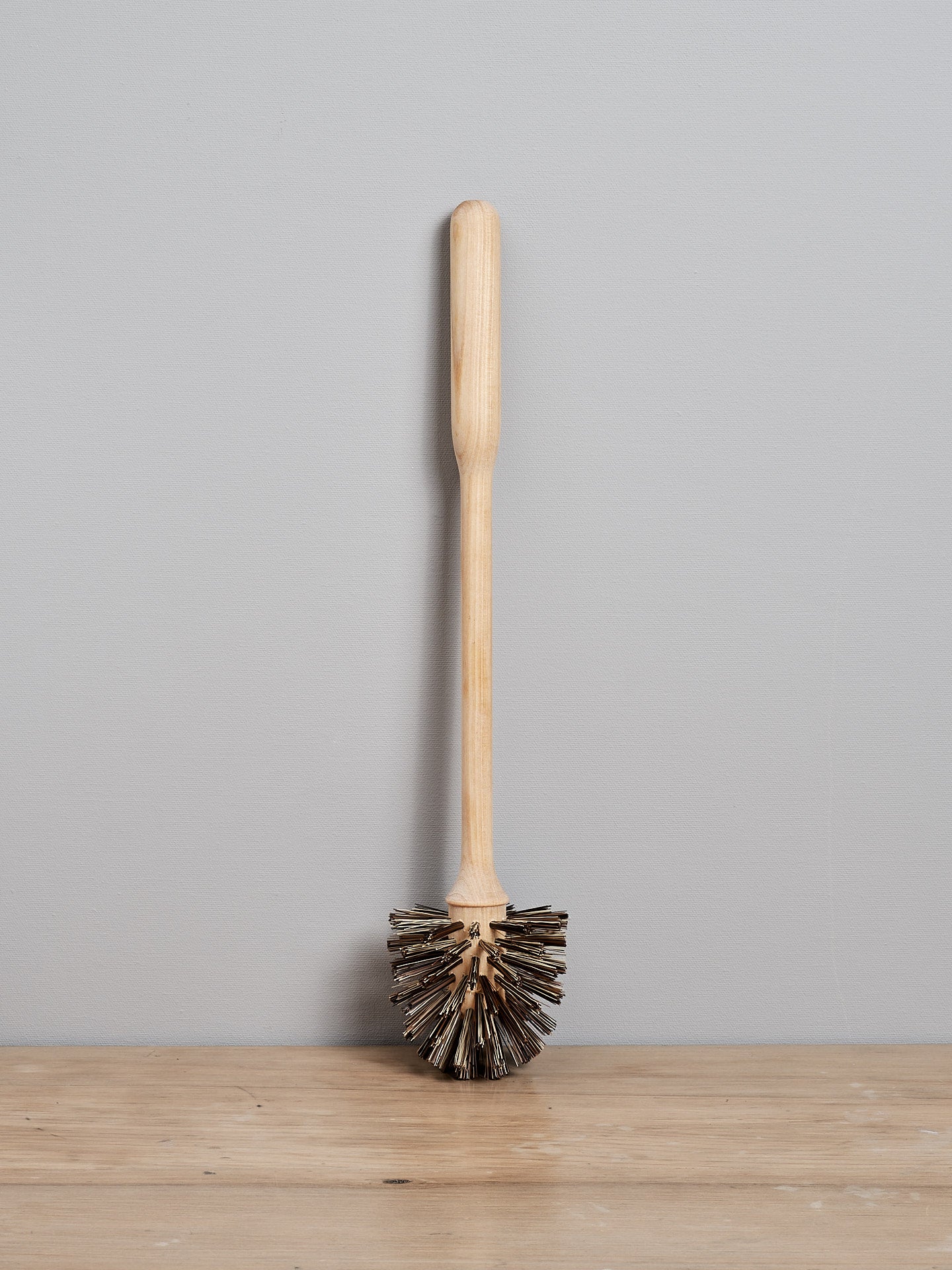 A Toilet Brush - Replacement by Iris Hantverk sitting on top of a wooden table.