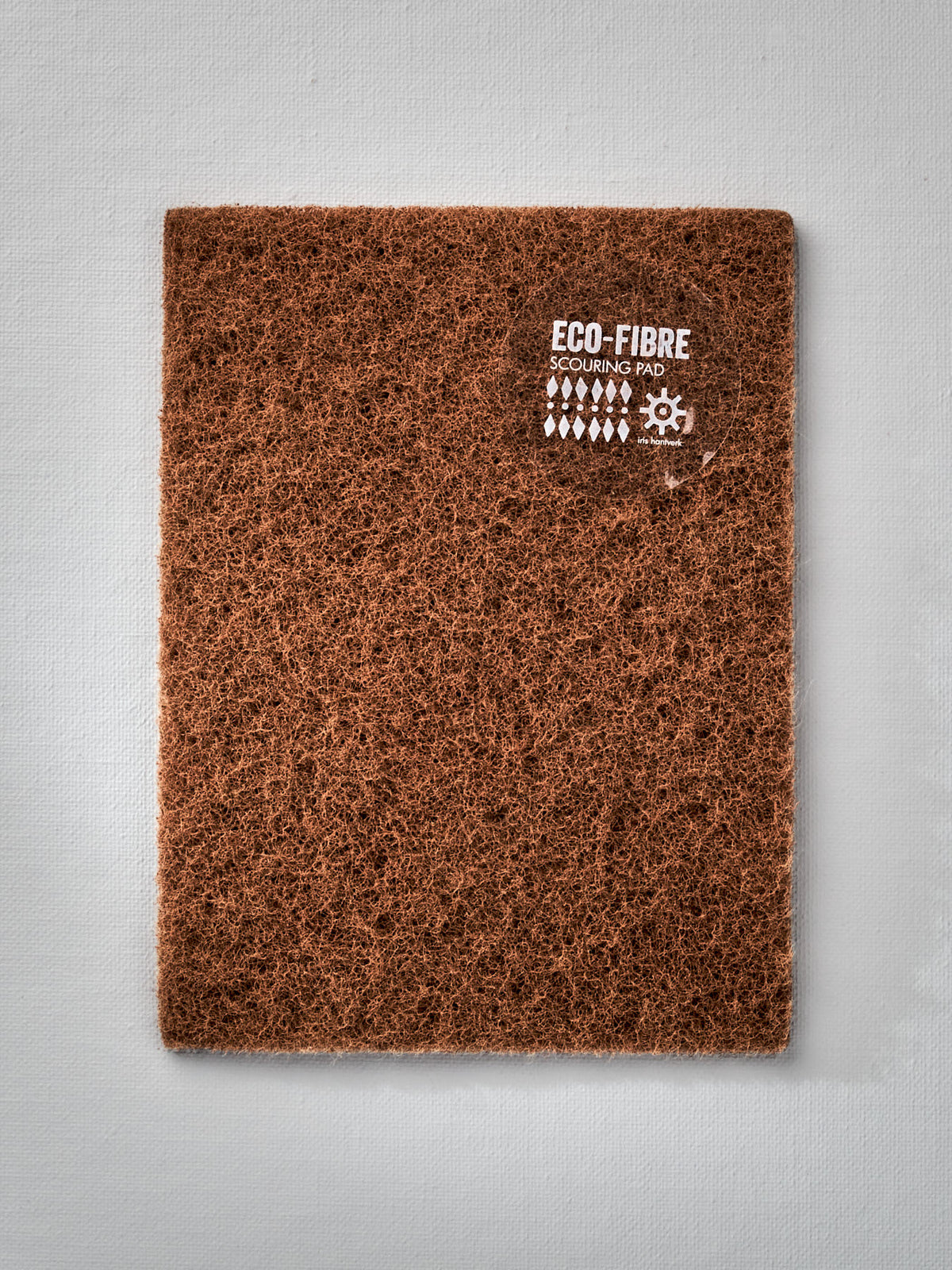 A brown Eco-Fibre Scouring Pad with the brand name Iris Hantverk on it.