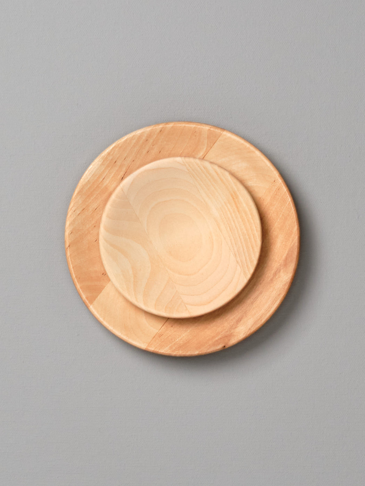 An Iris Hantverk Wooden Plate – Large on a gray background.