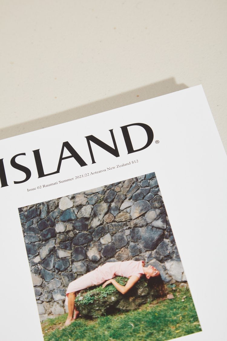 The cover of ISLAND Magazine – Issue 02 (Summer 2021/22) with a woman laying on the ground.